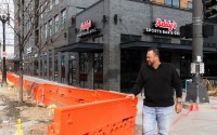 Addy’s Sports Bar and Grill owner Tim Addison stands next to the construction work that has disrupted business at his location in Omaha’s Capitol District. 
(Naomi Delkamiller / Flatwater Free Press)