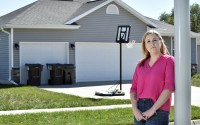 Jenn Burruss stands outside her home in Hickman, Nebraska, Sunday, Sept. 24. Burruss was shocked recently when she learned that her homeowner’s insurance premium had doubled in one year. 
(Eric Gregory / Flatwater Free Press)