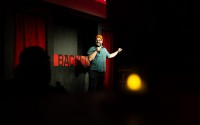 The Backline’s owner Dylan Rohde introduces the last act of a comedy showcase in late February. After starting The Backline in the basement of an art studio, Rohde moved The Backline to its current home on Harney Street. 
(Joseph Saaid / Flatwater Free Press)