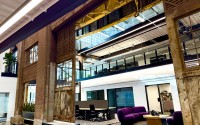 A section of the Catalyst that features desk areas and smaller offices for lease. Above is the gantry crane that used to move steel around in the plant. 
(Cindy Gonzalez / Nebraska Examiner)