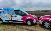 Two Dari milk trucks were parked at the site where a 240,000-square-foot milk processing plant is to rise at the Seward Rail Yard industrial park.
 (Cindy Gonzalez / Nebraska Examiner)

