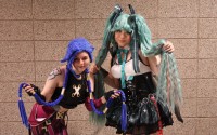 Faith S. (left) and Mira O. on the right showing off their cool cosplays to an awkward journalist in a lavender button-up and purple tie. 
(Austin Petak / The Daily Record)