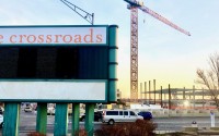 The Crossroads shopping center’s familiar sign shown here at the corner of 72nd and Dodge Streets, a high-profile intersection in Omaha that is undergoing huge changes. This view is looking south, toward the central library facility under construction. The Crossroads redevelopment team is requesting revisions that include an increase in the public tax incentive called tax-increment financing.
(Cindy Gonzalez / Nebraska Examiner)