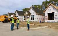 Joe Slosburg (right) talks to crew members at Aerie Blue Sage residential area under construction. They’re standing in a section where stand-alone cottages are rising and will be rented. Slosburg calls it a “modern neighborhood” of build-to-rent, mostly single-family homes. Industry leaders say the model is a growing trend. 
(Cindy Gonzalez / Nebraska Examiner)