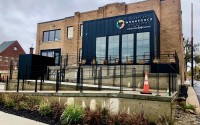 The new South Omaha site for Heartland Workforce Solutions at 4425 S. 24th Street. The $3.2 million renovation project transformed a fire-damaged, condemned funeral parlor into the workforce development, one-stop shop that also will contain a coffee shop. The nonprofit Canopy South is landlord and developer, tapping mostly philanthropic funds for the renovation. HWS used American Rescue Plan Act grant funds to cover its costs to open in the facility. 
(Cindy Gonzalez / Nebraska Examiner)