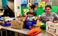 Volunteers and staff at the Together food pantry in downtown Omaha help people in need pack up their free grocery items this week.
 (Cindy Gonzalez / Nebraska Examiner)