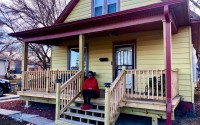 Mitzi Johnson sits on the new front porch of her North Omaha home that was improved with help from a zero-interest home renovation loan provided through the Greenlining Fund of Front Porch Investments. The fund is an effort to help reverse lingering negative effects of historic redlining and racially-biased credit practices. 
(Cindy Gonzalez / Nebraska Examiner)