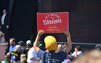 A youngster holds up a pro-union sign during a break between speeches on Labor Day at Laborfest in Milwaukee. Both presidential candidates are trying to appeal to union members. 
(Erik Gunn / Wisconsin Examiner)