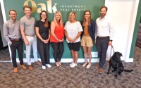 The Oak Investment Real Estate celebrates its first anniversary in October. The team (from left to right): Spencer Goldenberg, Colten Adams, Collen Mason, Michelle Gillott, Carol Samway, Dani Berke, and John Heine (and Louie the Lab). (Tim Trudell / The Daily Record)
