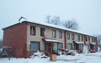 Snow falls on an abandoned apartment building that previously made up part of the Spencer Homes public housing development. 
(Jeremy Turley / Flatwater Free Press)