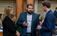 State Sen. Eliot Bostar of Lincoln (center) is flanked by State Sens. Carolyn Bosn and Beau Ballard both of Lincoln, April 10, 2024. 
(Zach Wendling / Nebraska Examiner)
