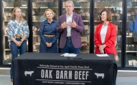 Gov. Jim Pillen (center) hosts a news conference at Oak Barn Beef in West Point announcing new regulations and future legislation to crackdown on “fake” or “lab-grown” meat in Nebraska on Thursday, Aug. 29, 2024. Behind him are, from left: Hannah Klitz, co-owner and co-operator of the family led Oak Barn Beef; Jeanne Reigle of Madison, a livestock producer and 2024 legislative candidate; and Director Sherry Vinton of the Nebraska Department of Agriculture. 
(Zach Wendling / Nebraska Examiner)