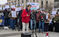 Connor Phillips, 25, told a crowd at a rally for federal workers that he’s losing his unpaid research training position at the National Institutes of Health, where he studies therapies for children with cerebral palsy. Phillips, who has benefited from cerebral palsy treatment, attended the rally outside the U.S. Department of Health and Human Services in Washington, D.C., on Feb. 19, 2025. 
(Ashley Murray / States Newsroom)