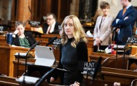 State Sen. Megan Hunt of Omaha glances at the speaking queue during debate. 
(Zach Wendling / Nebraska Examiner)