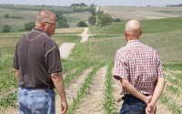 Stanton County landowner Justin Kennedy (left) speaks with a court-appointed appraiser as they look over land where the Nebraska Public Power District is taking an easement by eminent domain for a new transmission line. Kennedy said he hoped to build a home on the land someday, but those plans are now extinguished. 
(Jeremy Turley / Flatwater Free Press)