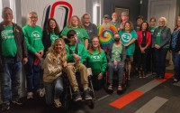 Supporters of medical cannabis joined together in support of two related ballot measures for the 2024 general election at a public hearing for Initiative Measures 437 and 438 at the University of Nebraska at Omaha on Friday, Oct. 25, 2024. Among those in the photo are Dominic Gillen (far left) and Shelley Gillen (left front row) who is kneeling by their son, Will Gillen.
 (Zach Wendling / Nebraska Examiner)