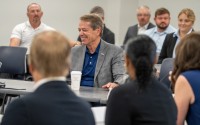 Nebraska Gov. Jim Pillen (center) addresses the new School Financing Review Commission during its first meeting on Aug. 12, 2025. 
(Zach Wendling / Nebraska Examiner)