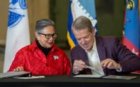 State Sen. Rita Sanders of Bellevue (left) joins Nebraska Gov. Jim Pillen for a ceremonial bill signing of Nebraska National Guard recruitment and retention legislation, Dec. 10, 2024.
 (Zach Wendling / Nebraska Examiner)