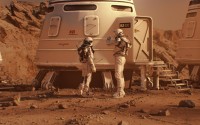 In this depiction, two astronauts in spacesuits walk toward research station on Mars. 
(Shutterstock)