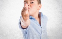 Kid doing a finger gun gesture.
(Shutterstock)