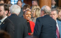 Nebraska lawmakers mingle with newly elected State Sen. Ashlei Spivey of North Omaha. She and others elected in November were sworn into office Wednesday — the first day of the 2025 legislative session. 
(Zach Wendling / Nebraska Examiner)