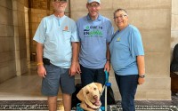 Josh Swanson, Josh Whitfield, Kathy Rohwedder and Whitfield’s service dog, Albert Noah Pooper, from left, joined a news conference announcing a crowdfunding website for Nebraskans to donate to accounts for people with disabilities, Aug. 14, 2024. 
(Zach Wendling / Nebraska Examiner)