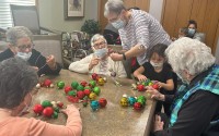 A new incentive grant program seeks to expand intergenerational care programs, combining care for children and older adults under one roof. Pictured are North Platte long-term care residents and a child from the neighboring Trucks N Tiaras Intergenerational Academy that already offers such combination. 
(Courtesy of Holly Hill)