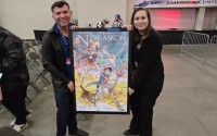 Executive Director of NAMI Nebraska, James Michael Bowers (left) holding up the highest value item sold at the NAMI Charity Auction, bought by Nebraskon Convention Chair Becky Potter (right), for $1000.
(Austin Petak / The Daily Record)