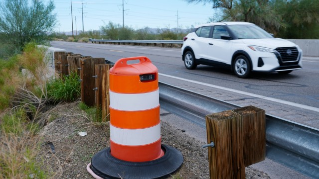 A license plate reader used by U.S. Border Patrol is hidden in a traffic cone while capturing passing vehicles on AZ Highway 85, Tuesday, Oct. 21, 2025, in Gila Bend, Ariz.
(Ross D. Franklin / AP Photo)