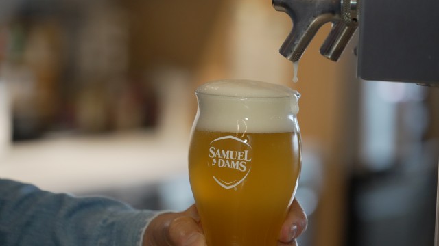 Beer froths after Boston Beer Co. Founder and CEO Jim Koch poured himself a drink at his company headquarters in Boston, Tuesday, July 7, 2026. 
(Rodrique Ngowi / AP Photo)