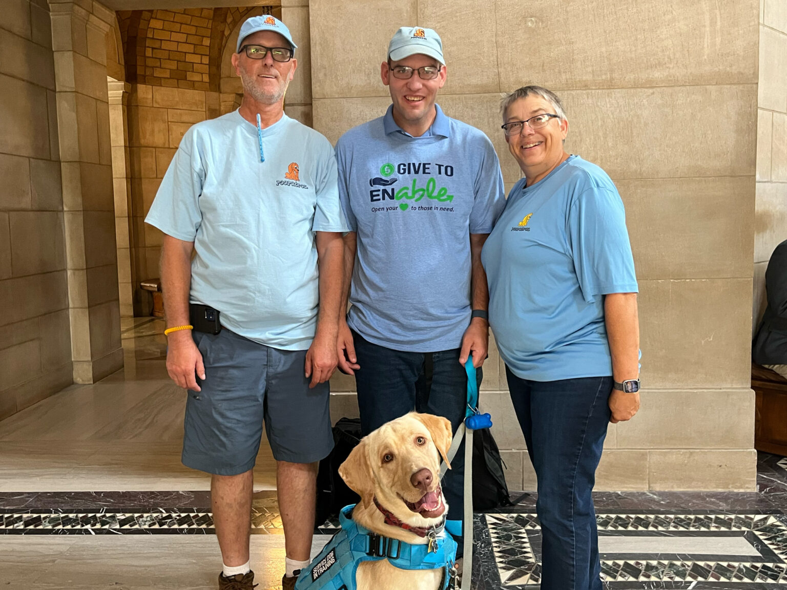 Josh Swanson, Josh Whitfield, Kathy Rohwedder and Whitfield’s service dog, Albert Noah Pooper, from left, joined a news conference announcing a crowdfunding website for Nebraskans to donate to accounts for people with disabilities, Aug. 14, 2024.<br />(Zach Wendling / Nebraska Examiner)