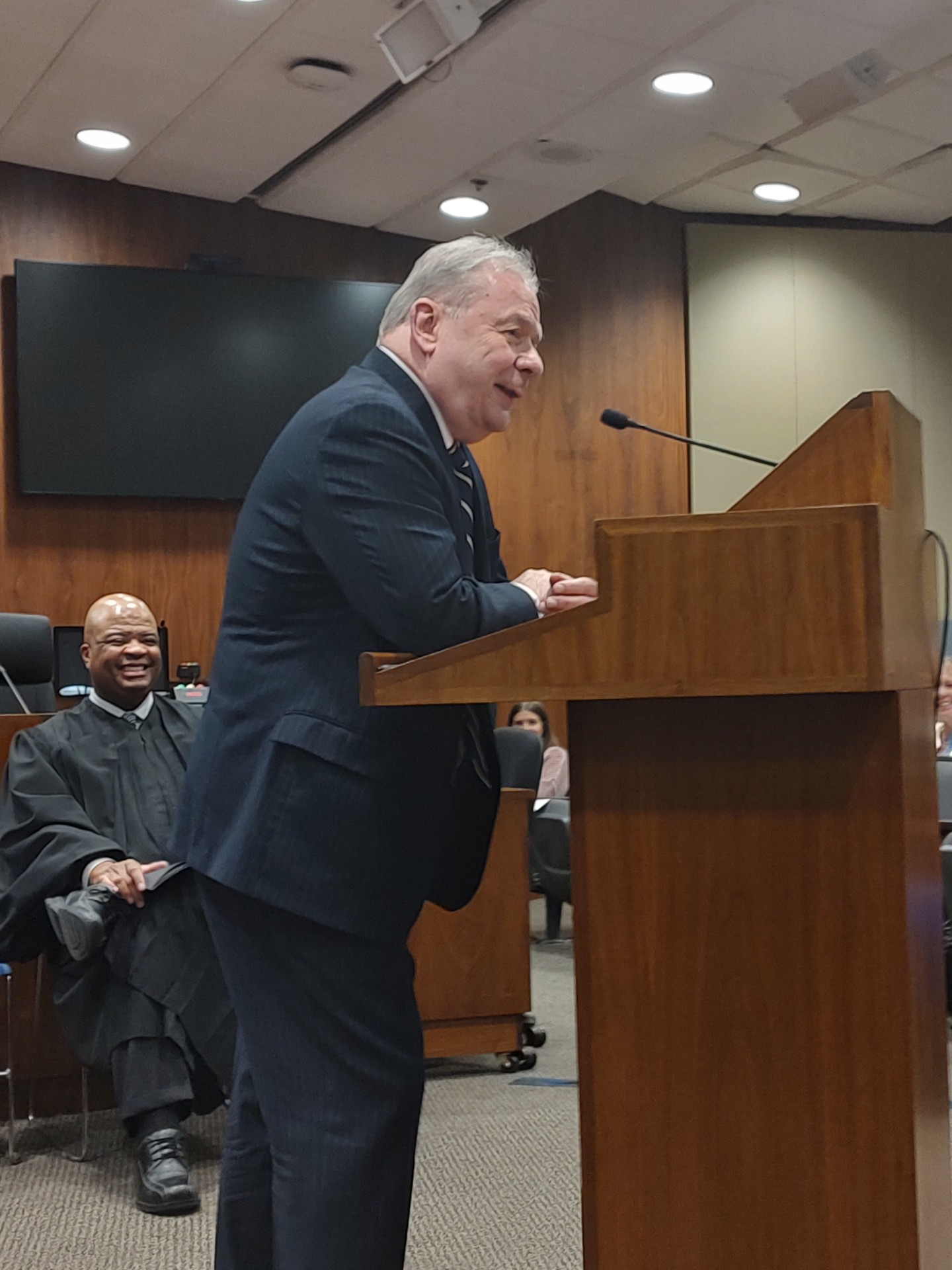 Douglas County Public Defender, Tom Riley, bringing smiles to the room, and to the Honorable Derek Vaughn, seated. <br />(Austin Petak / The Daily Record)