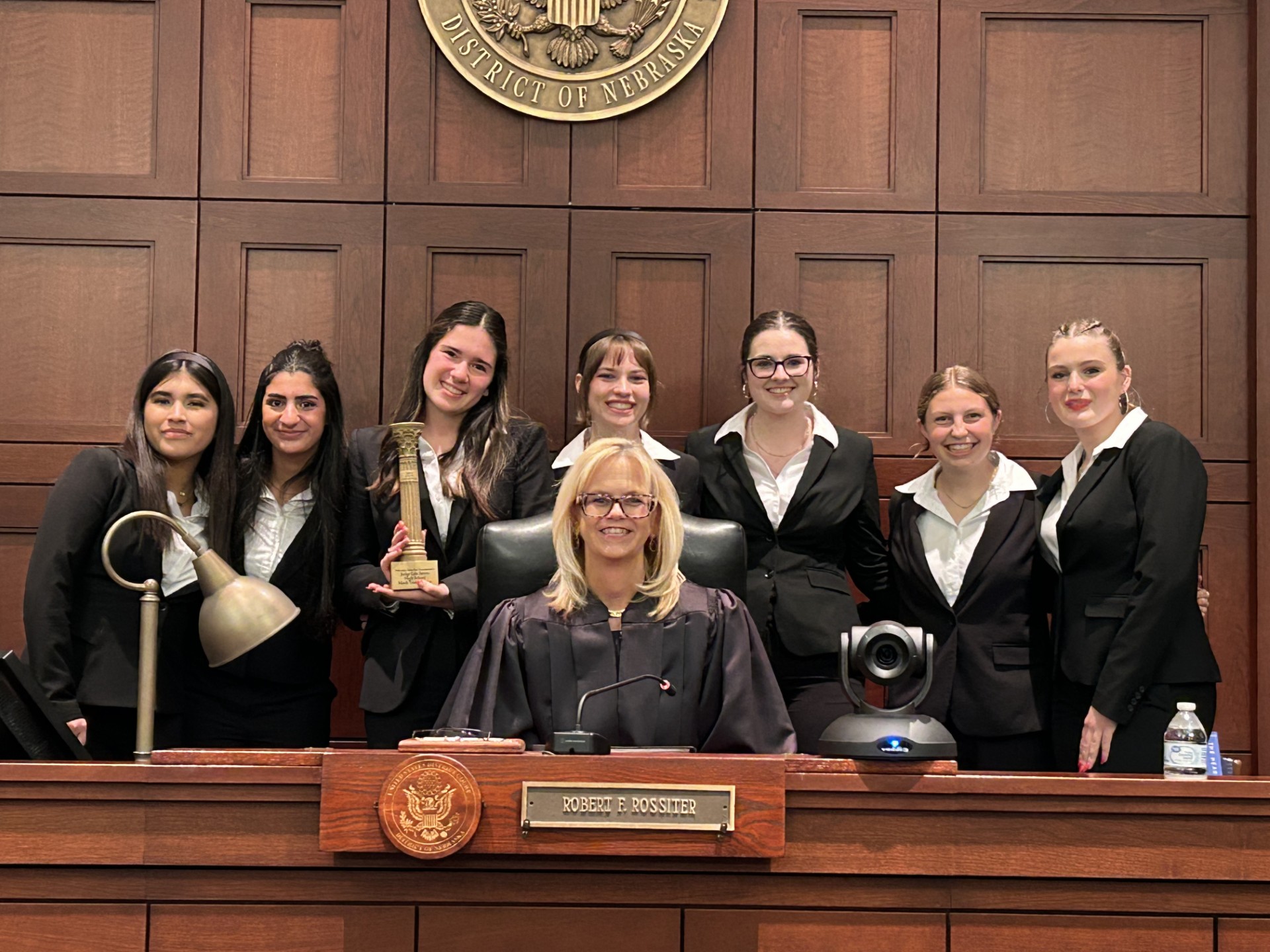 Duchesne&#039;s team appreciates and surrounds the Honorable Susan Bazis, a Federal District Court Judge in Omaha and the Presiding Judge in the State Final Round.<br />(Courtesy of Mark Laughlin)